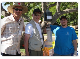 Tony Gill of sponsor PathWest, Dr. Inglis, and medical scientist Adam Merritt, with mosquito trap.