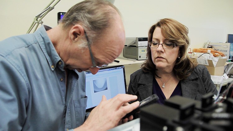 Carol Oxford and Ed Marquette examining the S3 cell sorter design