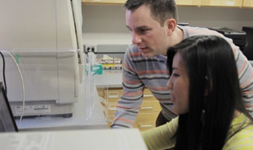 Ryan Jensen and Tiffany Nguyen examining gel images with the ChemiDoc MP imager