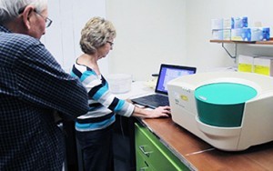 Researchers poring over data from Bio-Rad's droplet reader for absolute DNA quantification