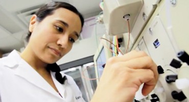 Picture of researcher plumbing the NGC chromatography system